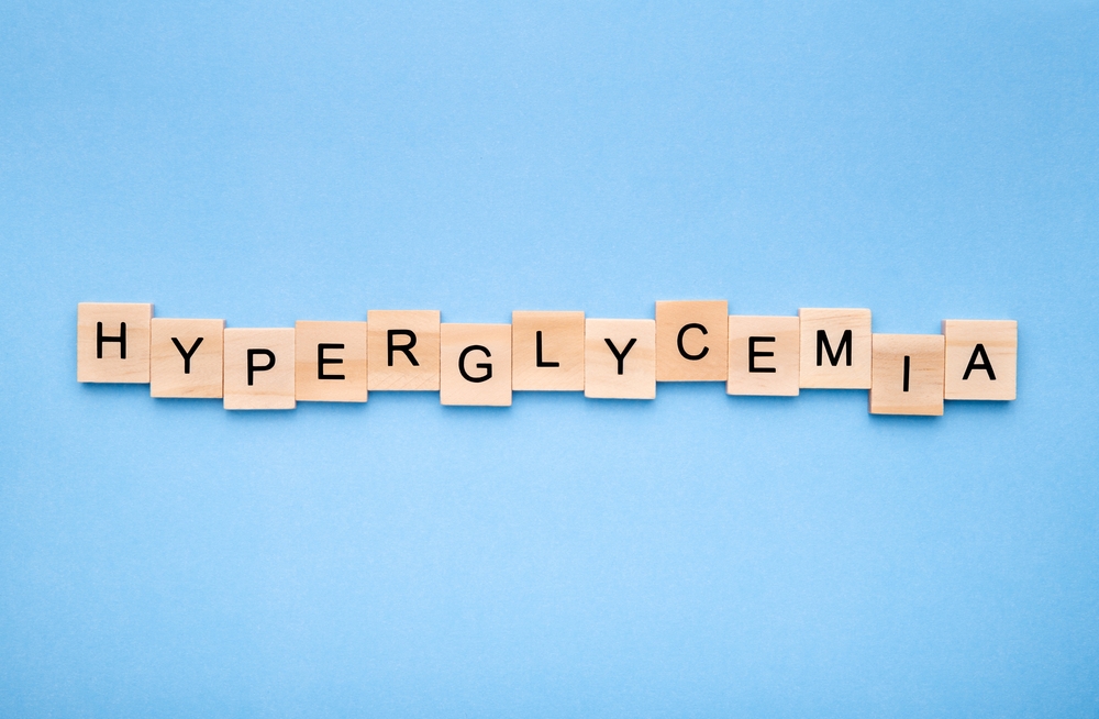 Word 'hyperglycemia' on wooden blocks on blue background