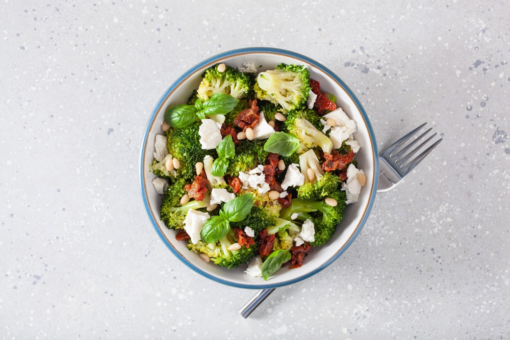 healthy broccoli salad with feta cheese sun dried tomatoes pine nuts.. vegetarian low carb keto diet