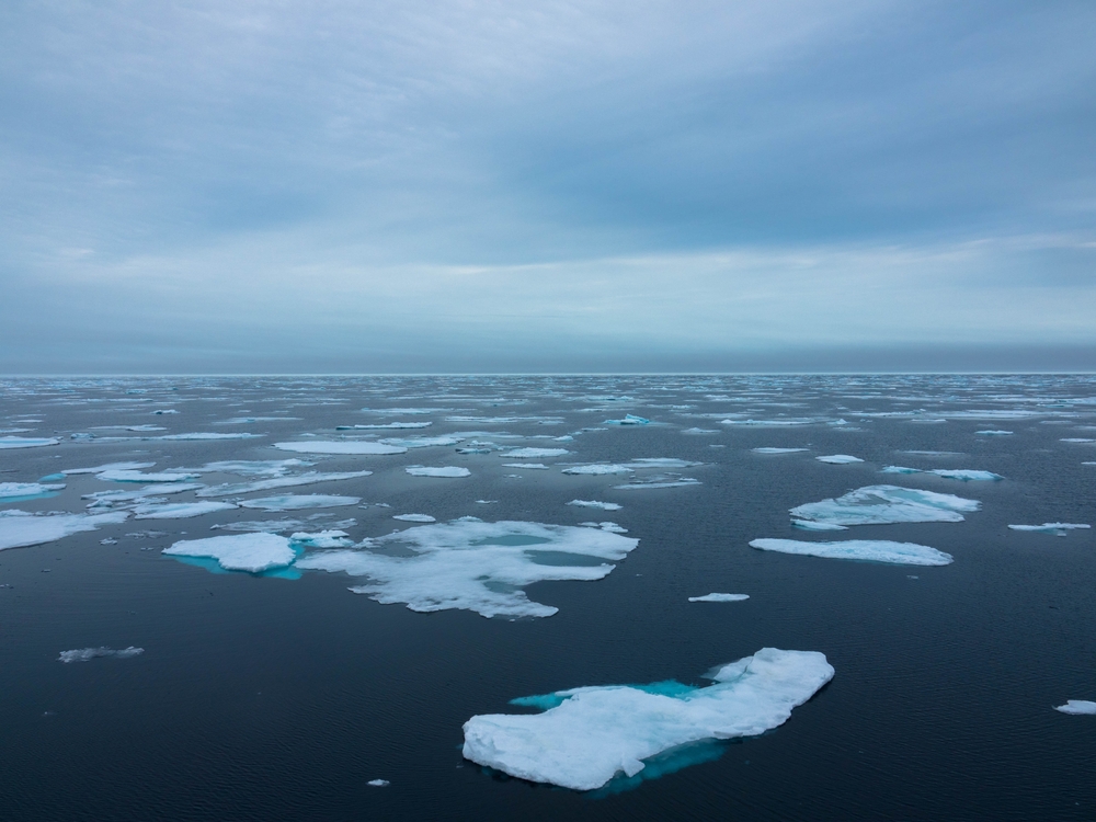 Floating Pack Ice in the arctic ocean. The snow covered blue glacial ice is an unspoilt wilderness but is fast melting due to climate change. Nordaustlandet, Svalbard, Norway. Place for text.