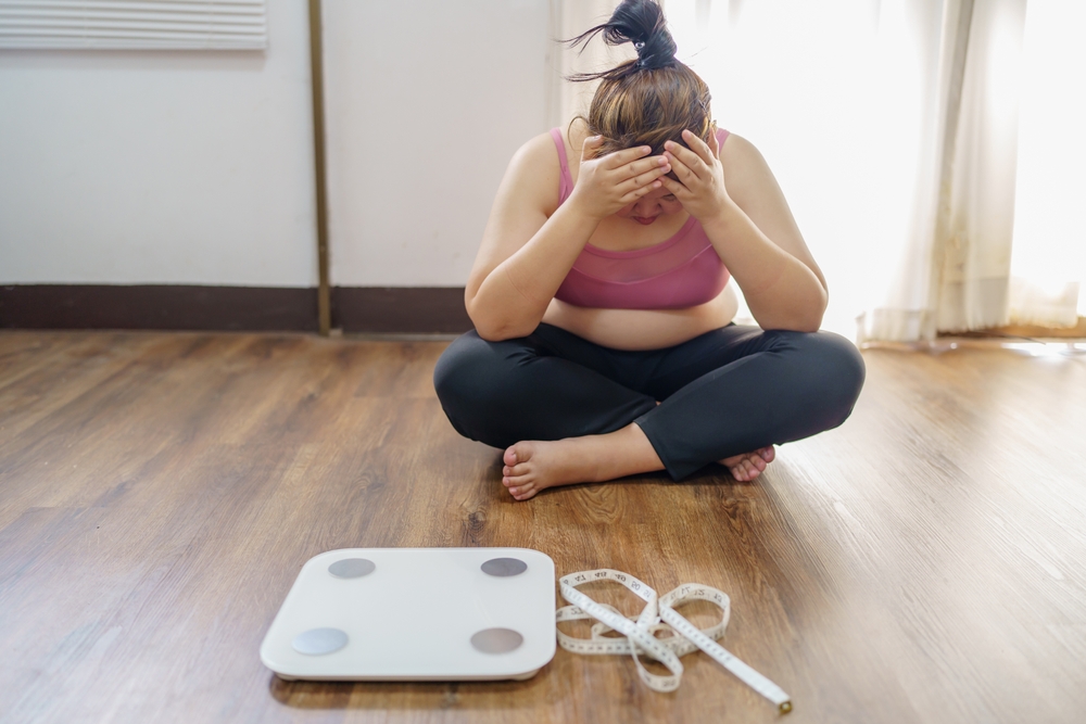 Obese Woman with fat upset about her belly. Overweight woman touching his fat belly and want to lose weight. Fat woman worried about weight diet lifestyle