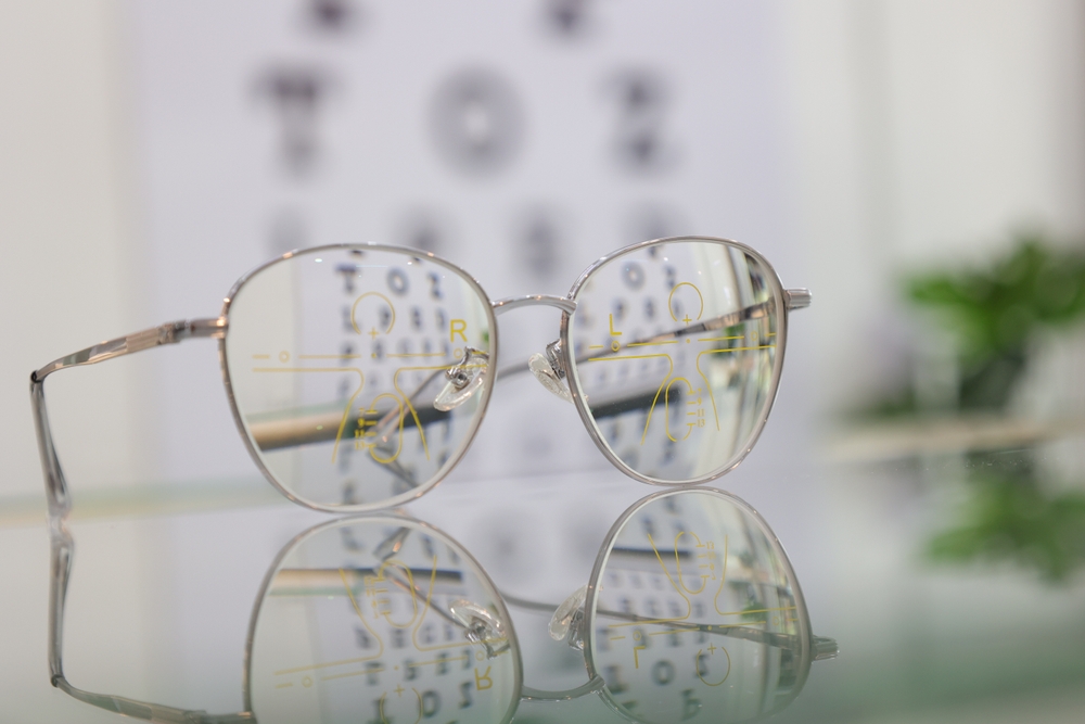 Eyeglasses on table, progressive lenses, eyeglasses for the elderly, glasses progressive lens, eyeglass progressive lens, close-up of glasses on blur background, looking through glasses
