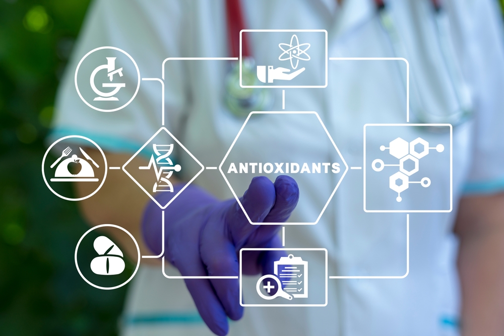 Doctor using virtual touch interface presses word: ANTIOXIDANTS. Natural Antioxidant Nutrition Healthy Eating Diet Medical Concept. Healthy foods rich in antioxidants.
