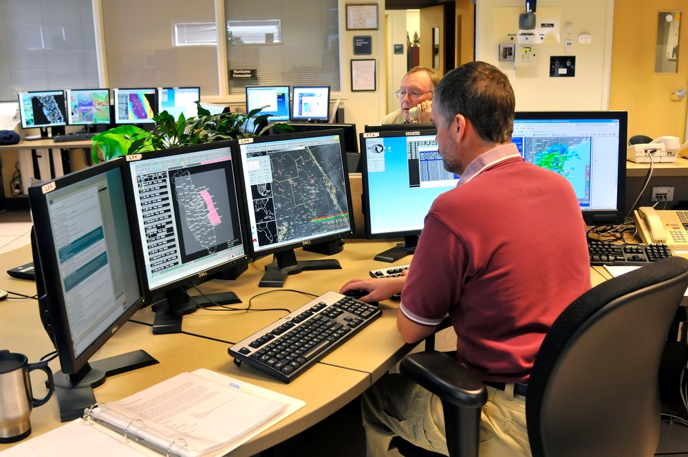 Meteorologist in Work Area in Doppler Radar Station with National Oceanic and Atmospheric Administration NOAA National Weather Service. Ruskin ,Florida ,Tampa Hillsborough County. created 07.09.23