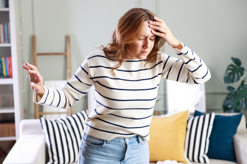 Young woman suffering from vertigo or dizziness problem of brain or inner ear