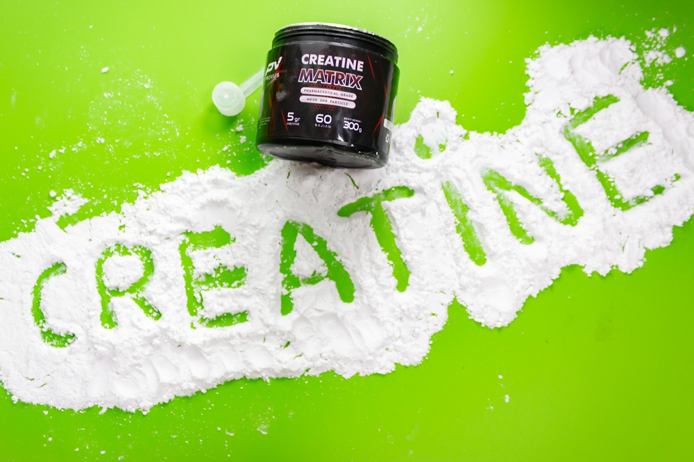 Bandung, Indonesia, 2024-01-10 : creatine fitness supplement powders with green background