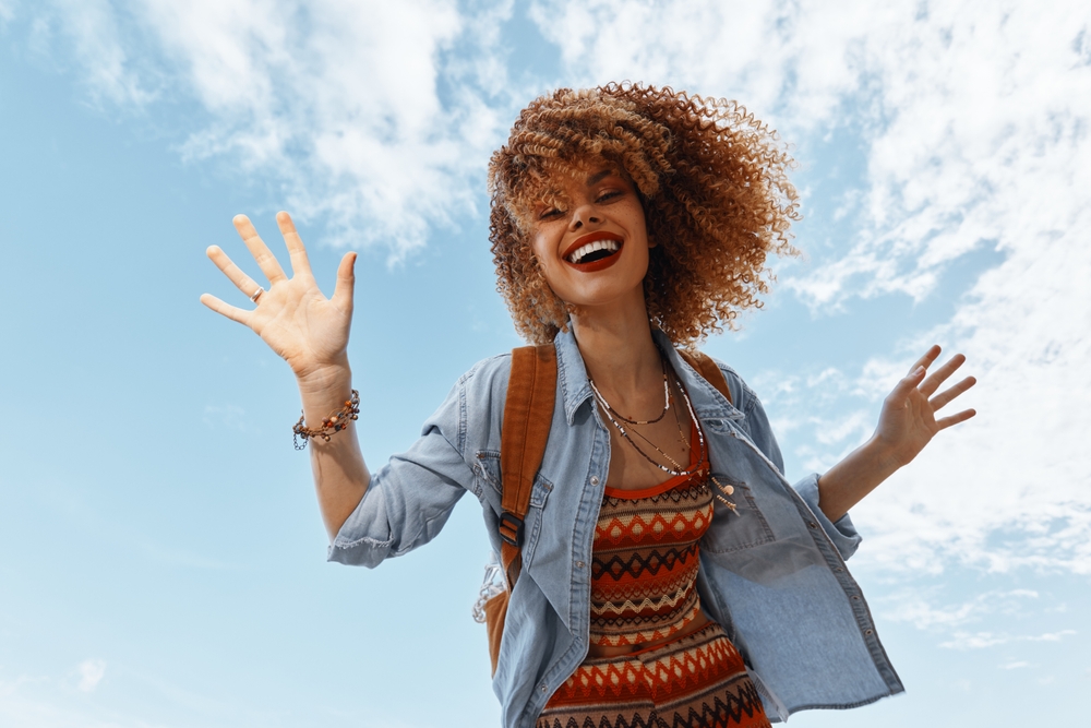 Happy Woman Dancing on the Beach, Embracing Freedom and Joy in Wide Angle View
