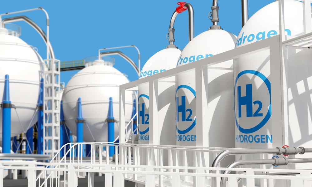Industrial hydrogen storage tanks with blue and white branding against a clear sky. Tanks for hydrogen storage. Production of clean energy from hydrogen. Tanks contain H2 to create electricity.