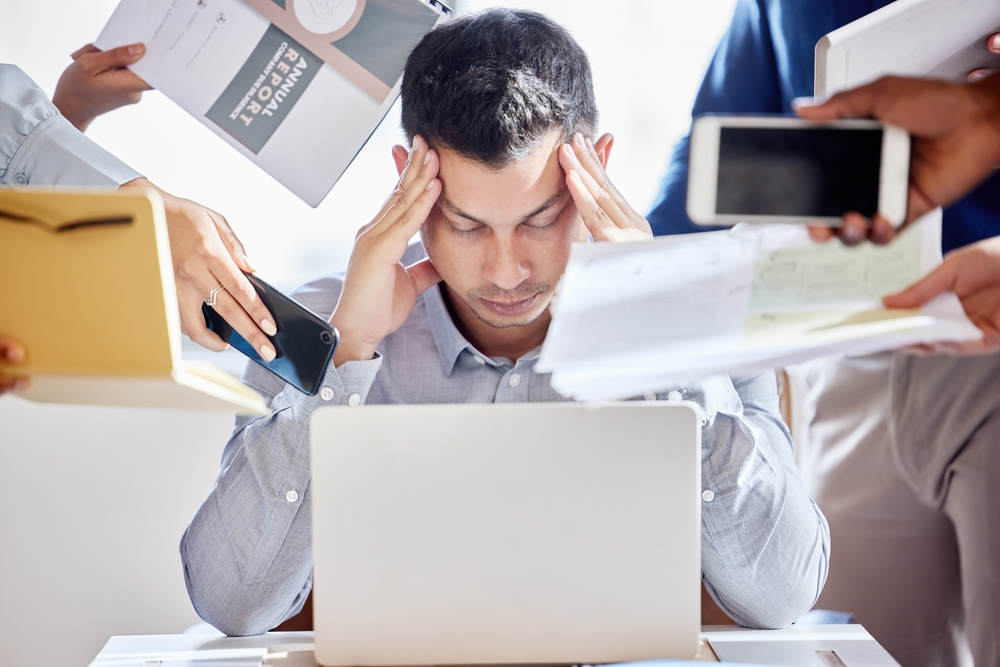 Business people, hands and man with stress headache in office for laptop multitasking, fail or deadline disaster. Migraine, crisis or accountant overwhelmed by team for tax, audit or compliance chaos