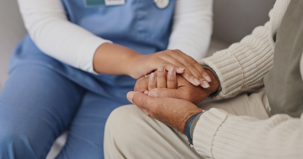 Senior care, support or nurse holding hands with person for healthcare service, wellness or empathy. Sympathy, closeup and caregiver helping for comfort, trust or patient for medical check or nursing
