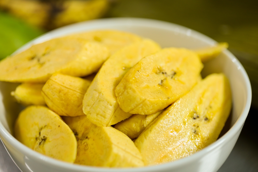 Yellow delicious sliced plantain in a white bowl