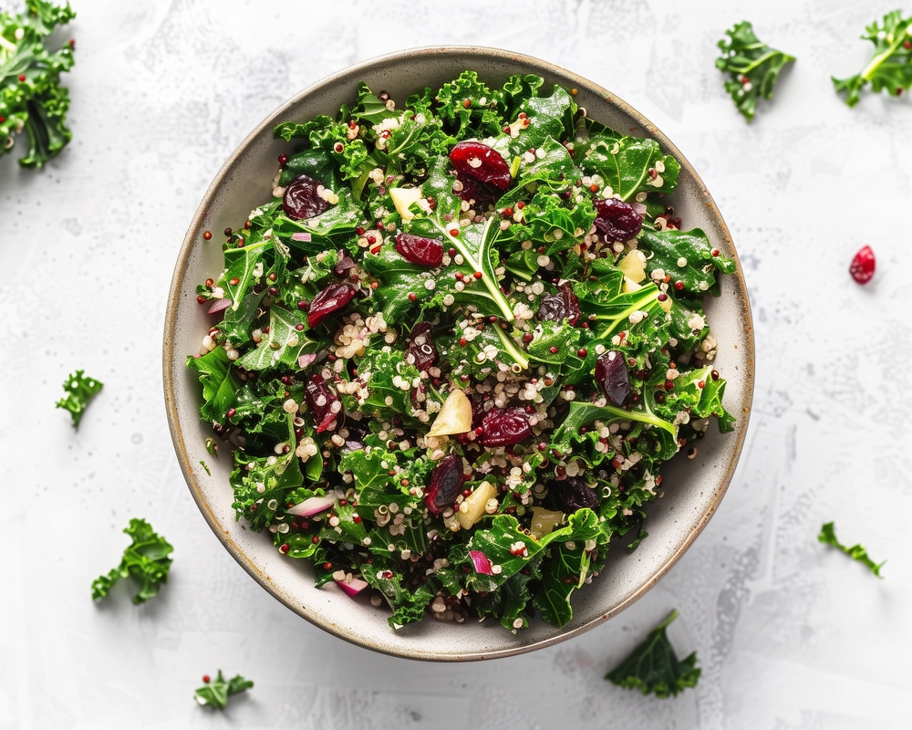 Kale and Quinoa Salad, Massaged kale mixed with cooked quinoa, dried cranberries, and a lemon-tahini dressing.