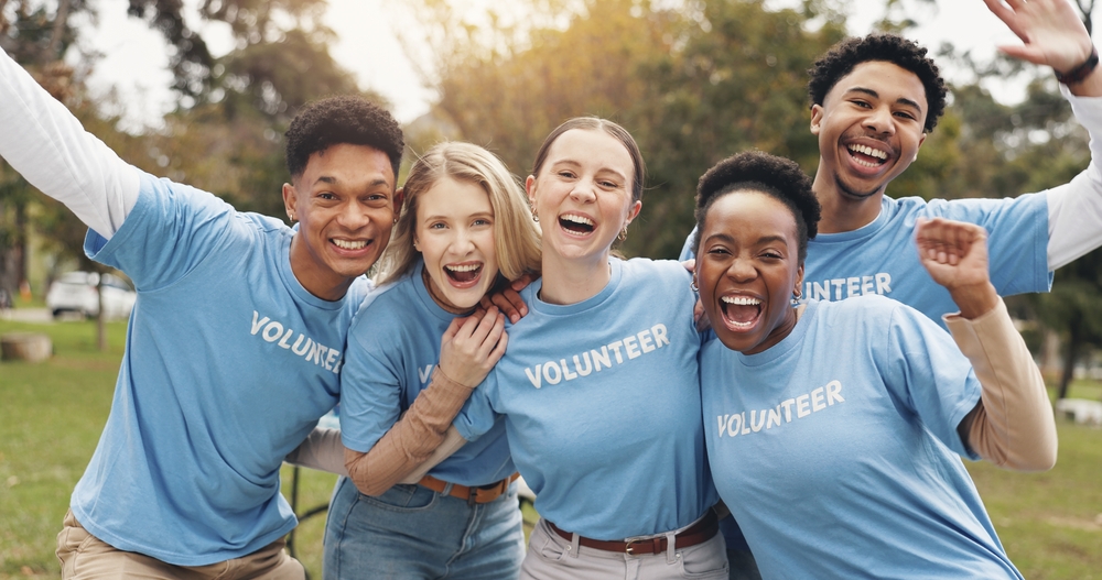 Happy, volunteer and portrait of people in park for charity event, community service and teamwork. Volunteering, happy and men and women with smile for donation, ngo business and outreach outdoors
