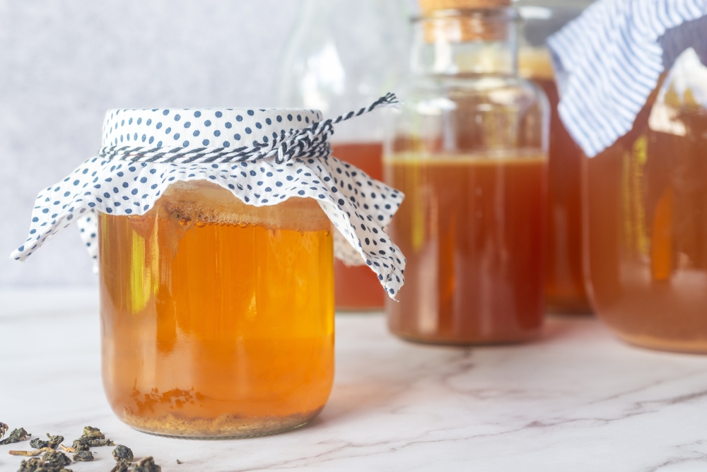 homebrew fermented drink Kombucha in a glass bottle jar, Kombucha SCOBY "symbiotic culture of bacteria and yeast" in glass bottle jar.
