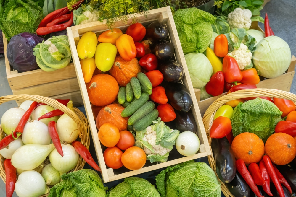 Organic vegetables. Healthy products from farmers market. Boxes with delicious fresh vegetables. Healthy food for diet. Various vegetables in baskets. Products from organic section of supermarket
