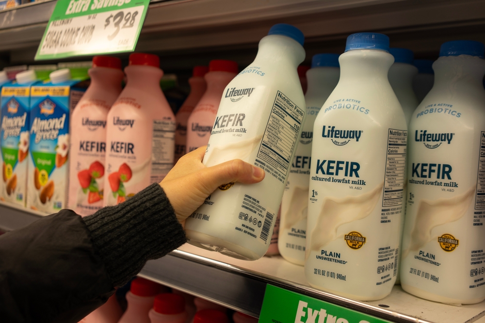 Tigard, OR, USA - Nov 13, 2023: A shopper chooses a bottle of Lifeway low-fat unsweetened kefir at a WinCo Foods store in Tigard, Oregon. Lifeway Kefir is a tart and tangy cultured milk smoothie.
