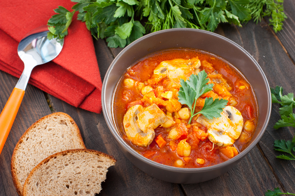 Serving vegetarian stew with chickpeas, mushrooms and pumpkin, horizontal