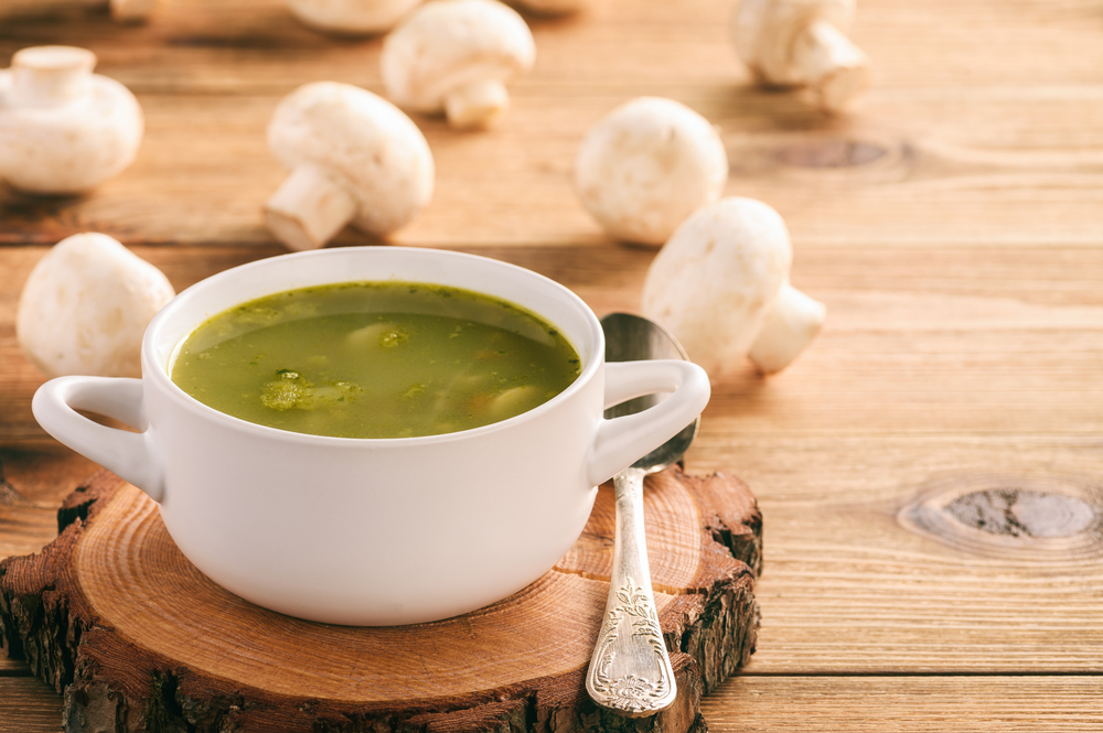 Vegetable soup with spinach, carrot and mushrooms.