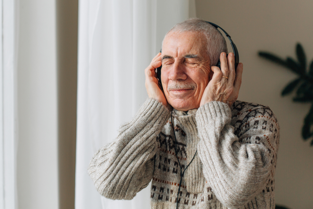 Handsome Senior man listening music