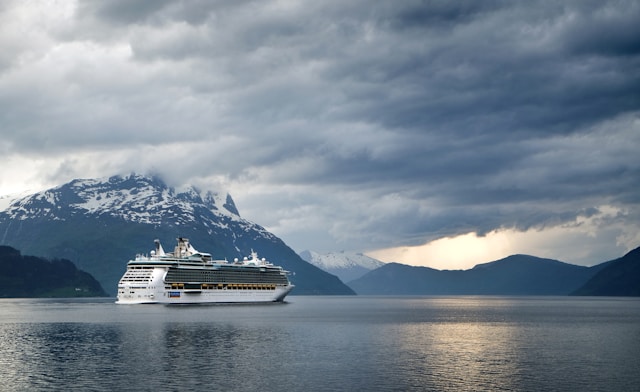 cruise ship sailing near mountains 