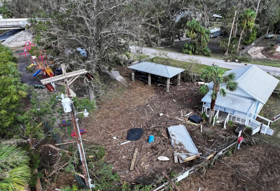 A home surrounded by fallen debris. 