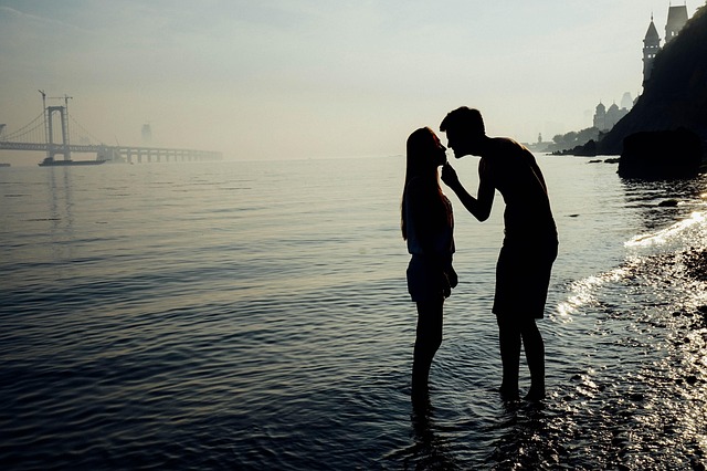 man and woman by beach