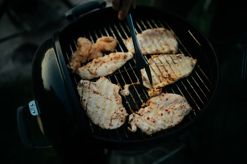 chicken on a grill with goop between