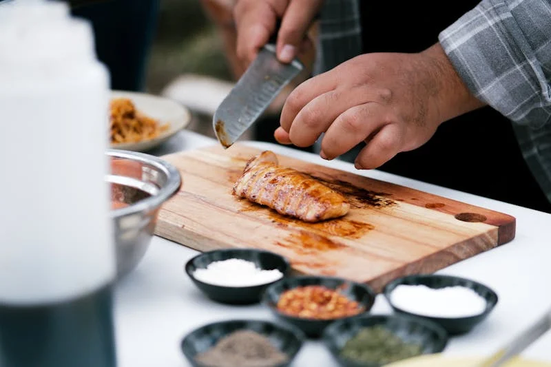 slicing chicken on a cutting board