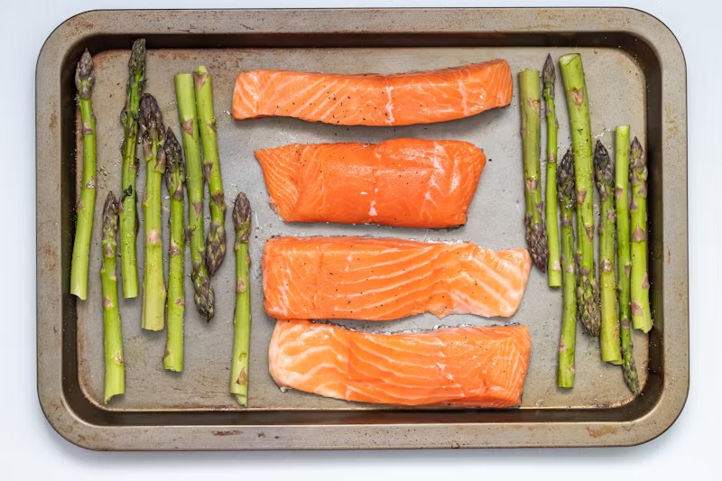 a roasting pan of salmon and asparagus