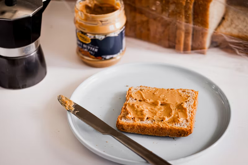 a piece of bread with. peanut butter on it