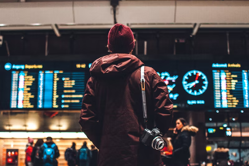 a person looking at flight information in an airport