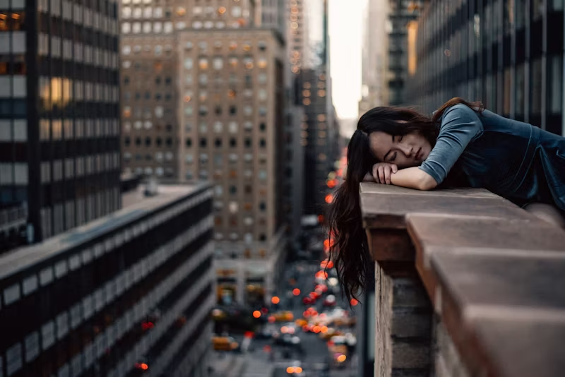 woman sleeping on a building ledge