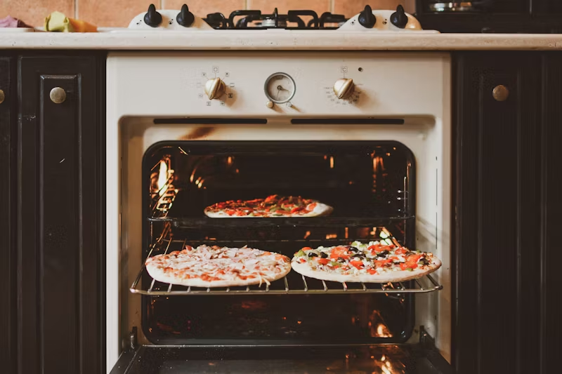 frozen pizzas in an oven