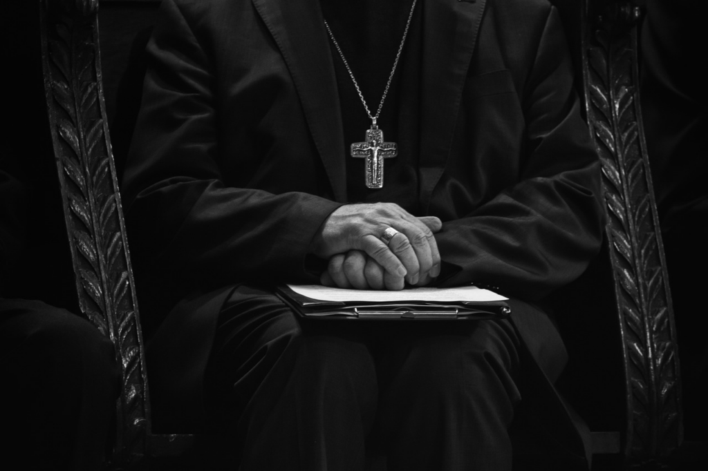 black and white photo of the bishop sitting