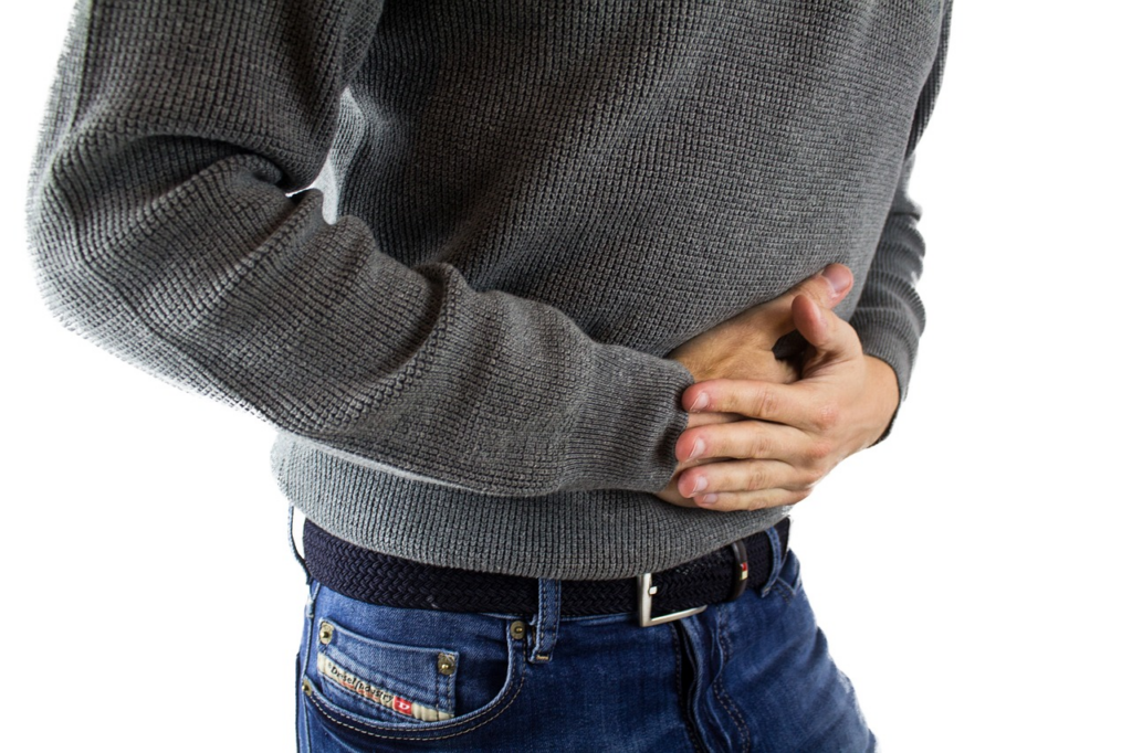 man holding his abdomen