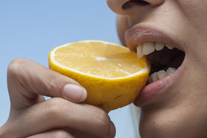 person eating a lemon