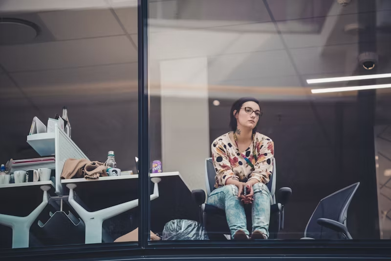 woman sitting looking out a building window