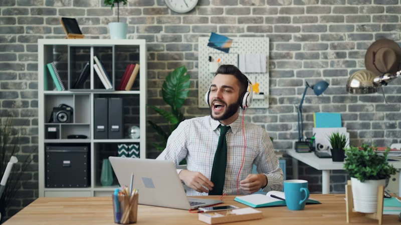 guy on laptop using headphones