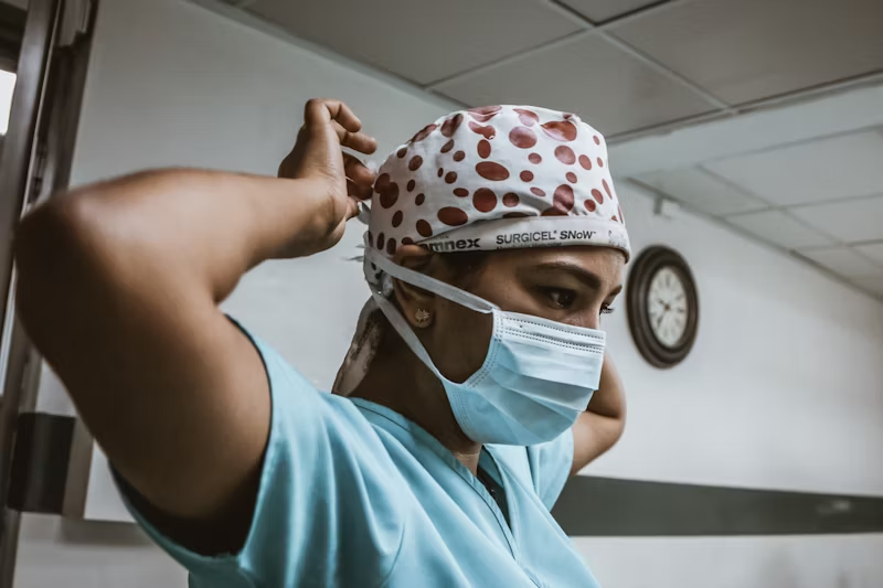 a doctor preps to examine her patient