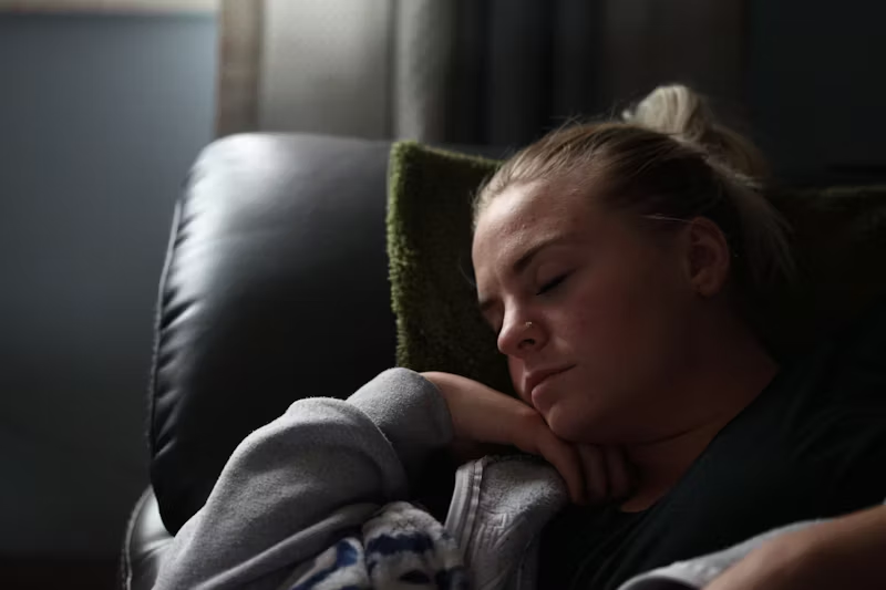 woman sleeps in a chair