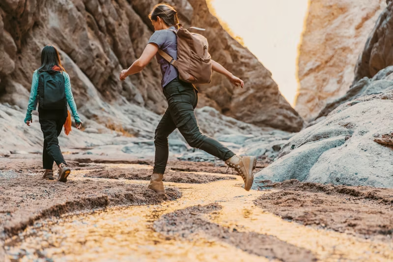 two women walking in a ravine