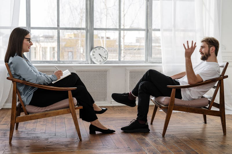 man and woman talking in therapy
