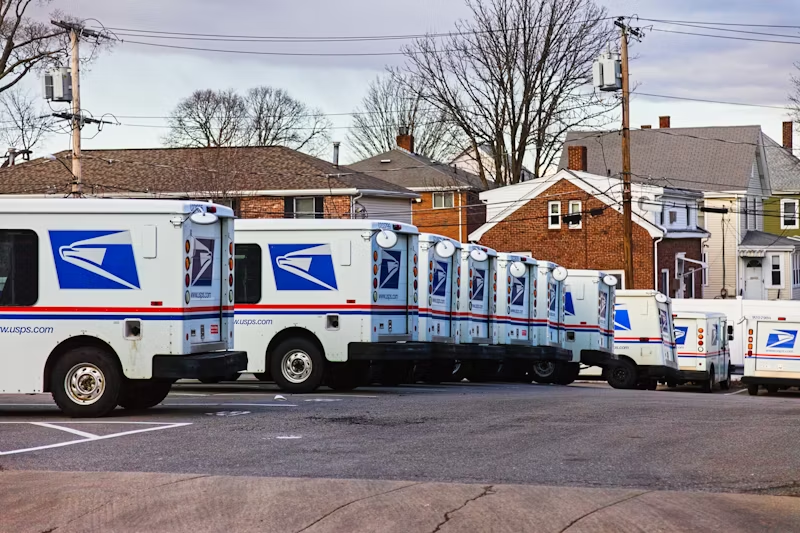 a fleet of USPS trucks