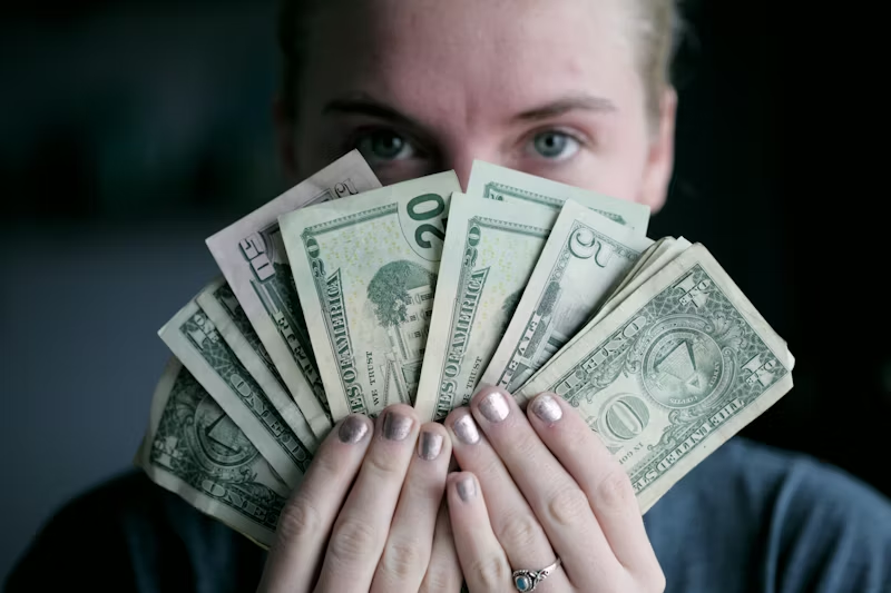 person holding a fan of money
