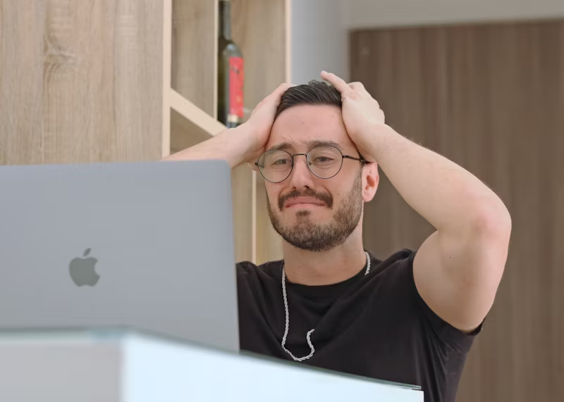 man with his hands in his hair