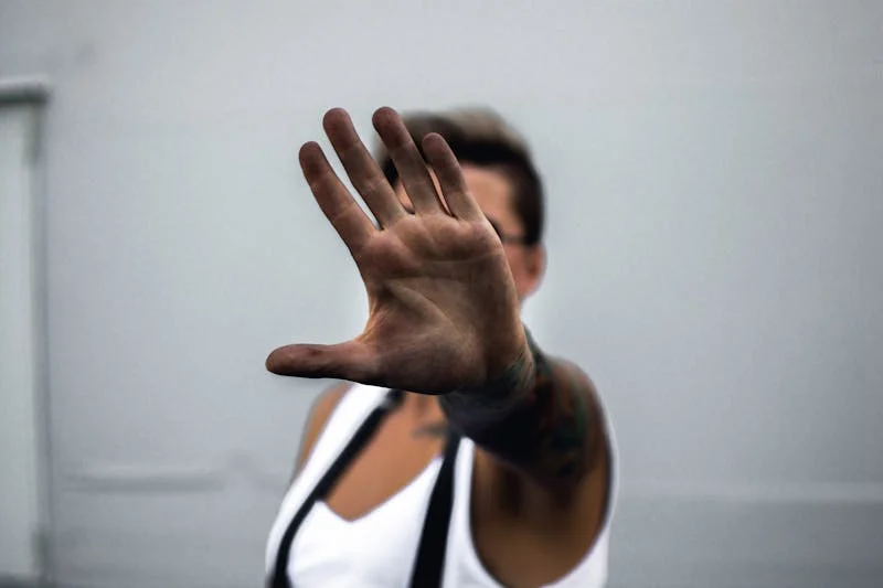 persons hand covering the view of their face