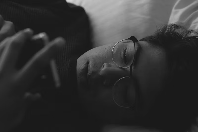 guy in bed on his phone