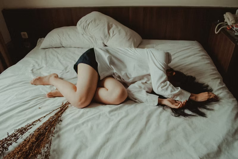 person sprawled on their bed