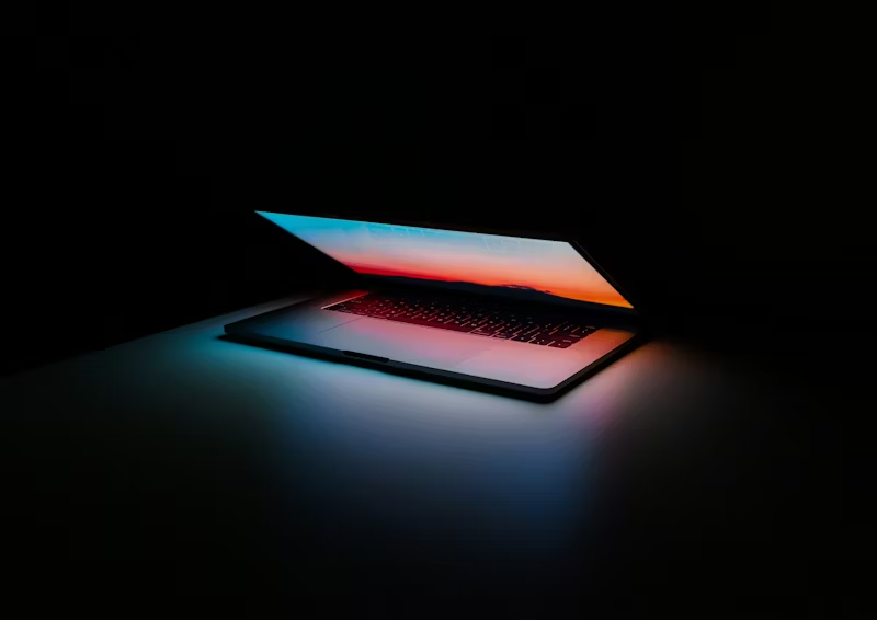 lit laptop in a dark room