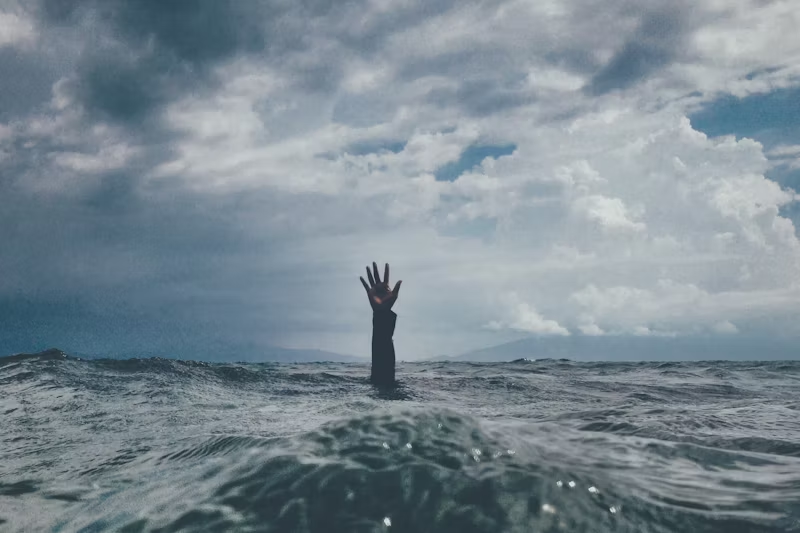 hand reaching out of the water
