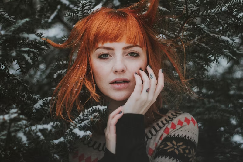 redhead woman among winter evergreens